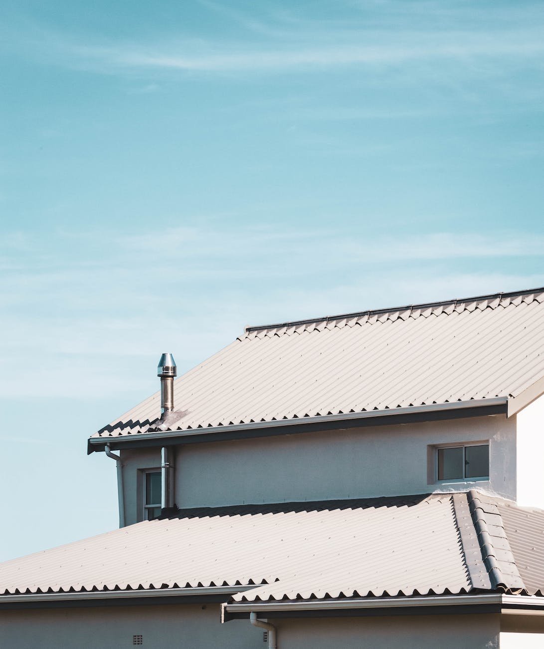 white roof of house under blue sky